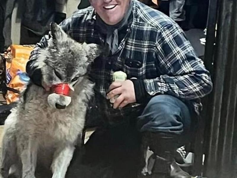 Cody Roberts kisses the adolescent female wolf he crippled with his snowmobile