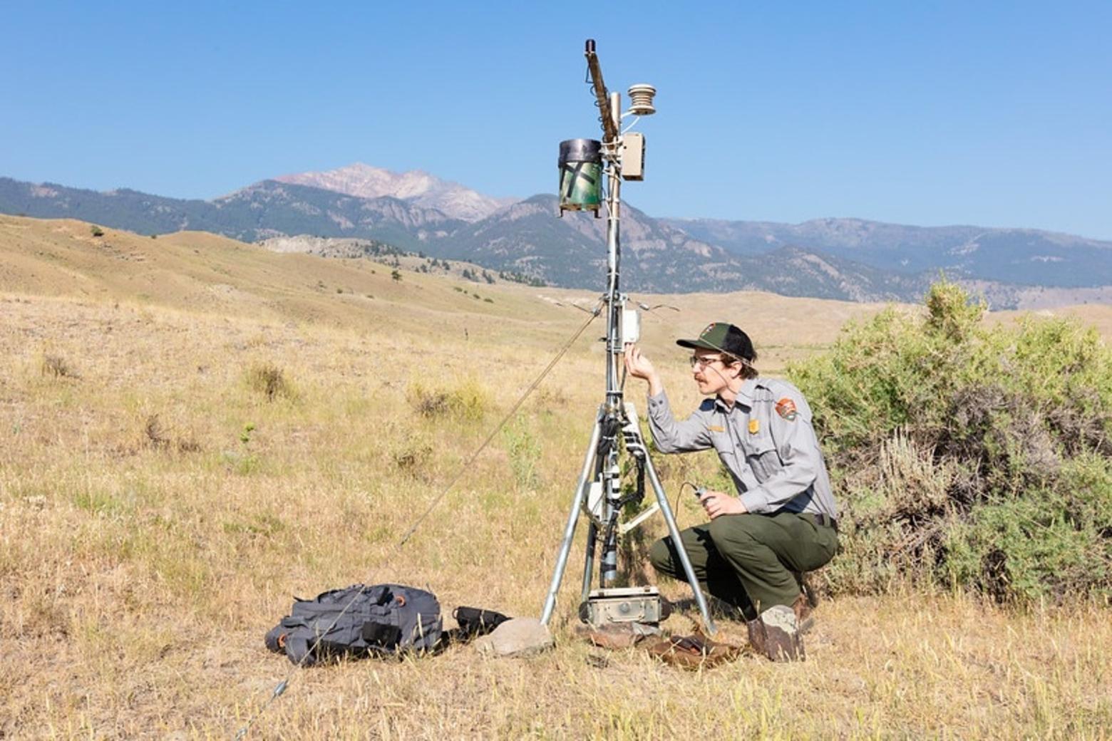 For 16 years, scientists, citizens and public officials have been convening for the Biennial Scientific Conference to discuss issues in Greater Yellowstone. Here, GIS Technician Ben Banet downloads data from a climate monitoring site. Photo by Jacob W. Frank/NPS