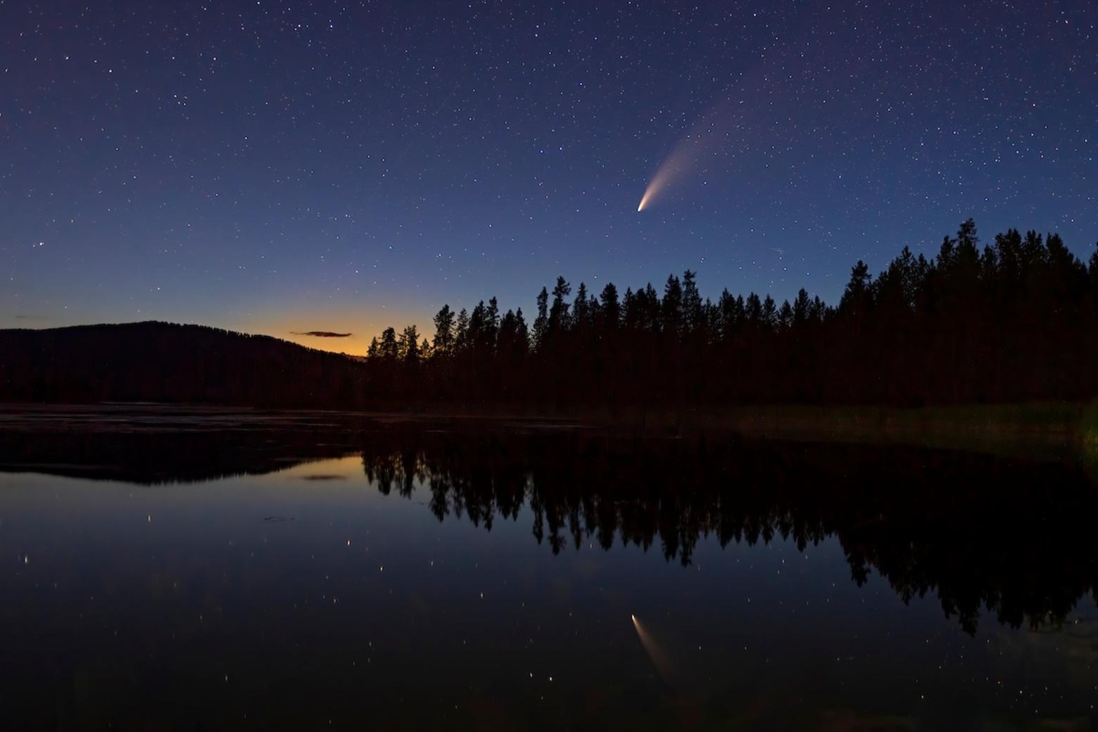 A shooting star pierces the night sky reflected over Harriman Ranch in Island Park, Idaho. Photo by Charlie Lansch/LastChanceGallery.com