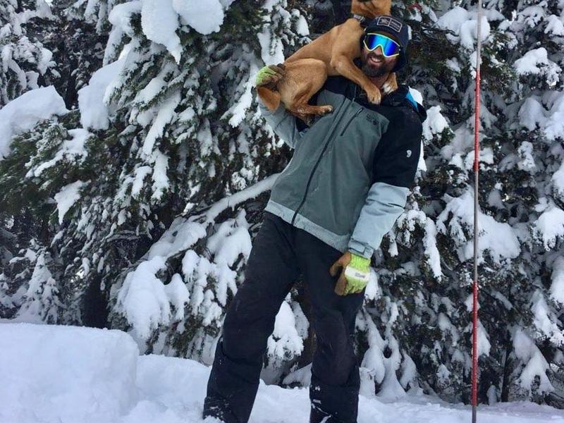 A snowman in his element with his dog Indy