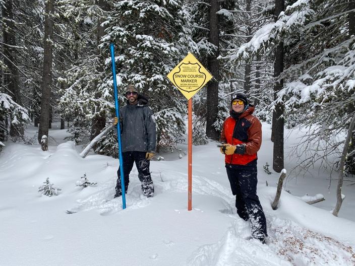 Eric Larson and Joe Kral pose at the Mudd Lake snow course near Deer Lodge, Montana. In addition to automated SNOTEL sites, NRCS also uses snow courses to take monthly snow depth measurements by hand.  Photo courtesy Eric Larson