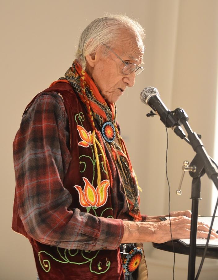 Salish elder and spiritual leader Johnny Arlee reads an 1876 speech by Salish leader Sɫm̓x̣e Q̓woxq̣eys (Claw of the Small Grizzly Bear), also known as Chief Charlo, which Arlee translated into the original Salish language for the debut of historian Sally Thompson's book "Black Robes Enter Coyote's World" on Dec. 18. Charlo's jeremiad recounted the broken promises and persecutions laid on his people as White settlers pressured them to leave their homeland in Montana's Bitterroot Valley. Photo by Robert Chaney