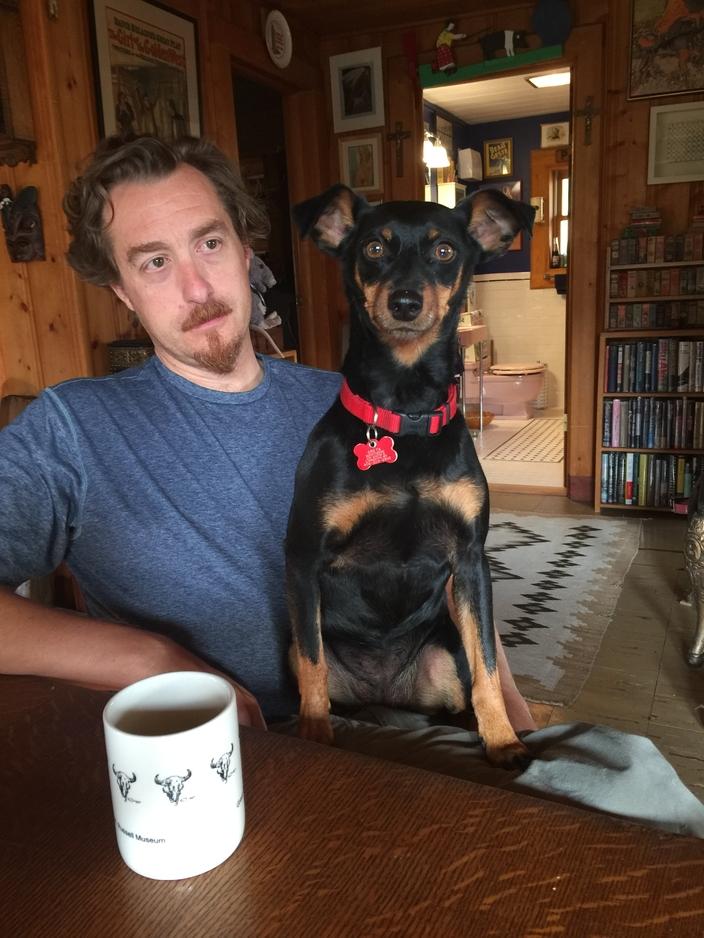 Max Hjortsberg sits with his dog, Greta, in his father’s cabin near the Main Boulder River. Photo courtesy Max Hjortsberg