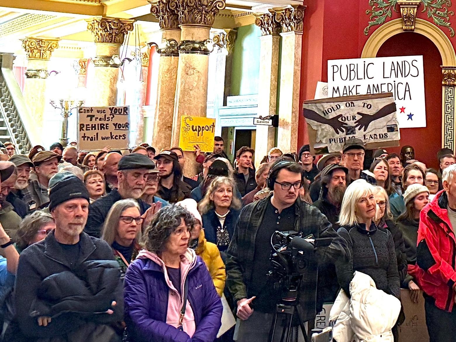 Public lands advocates gather for the Rally for Public Lands in Helena. Many carried signs protesting massive government layoffs. Photo by Amanda Eggert/MTFP