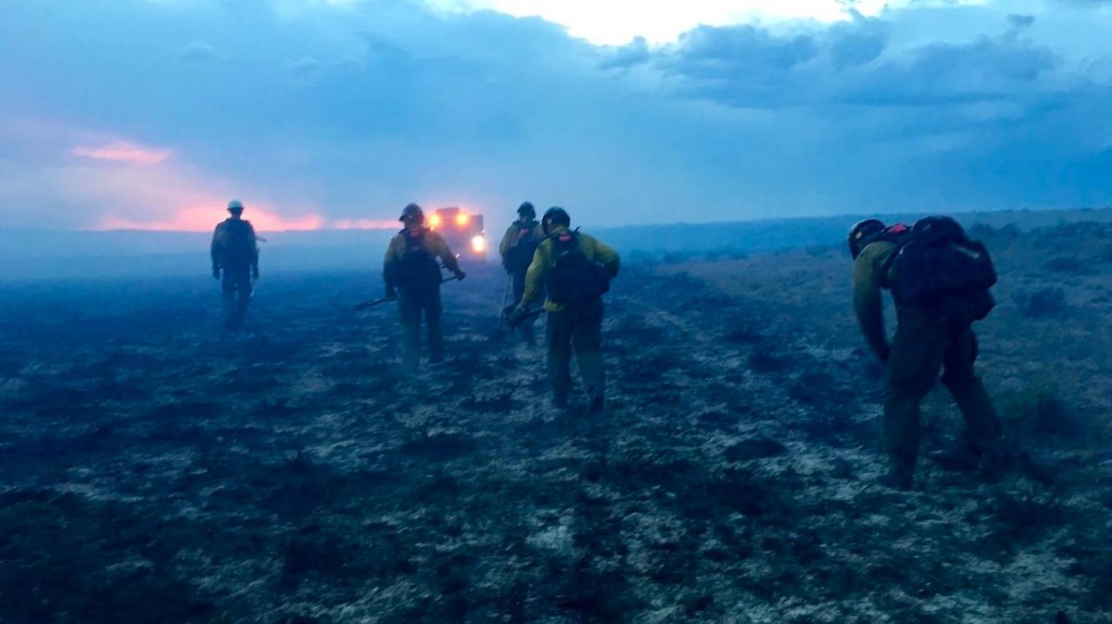 A Bureau of Land Management wildland fire crew works a fire in Montana during the record-setting 2017 fire season. Photo by Cody Phillips/BLM