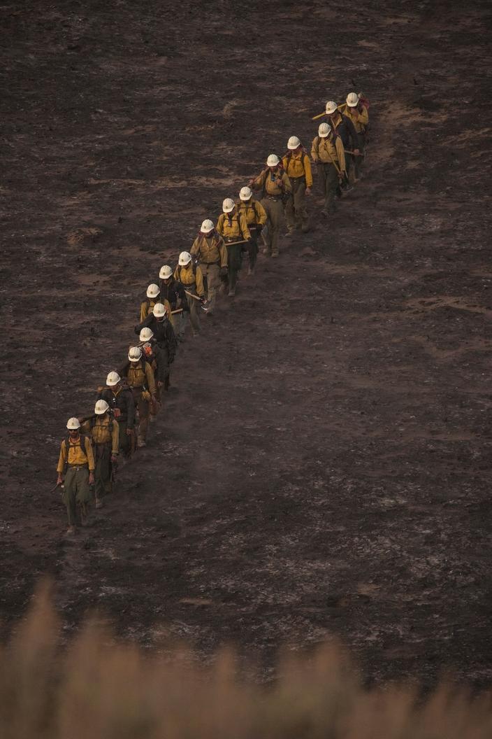 The Breckenridge Hotshots hike to the fireline of the Roosevelt Fire. Photo by Kari Greer