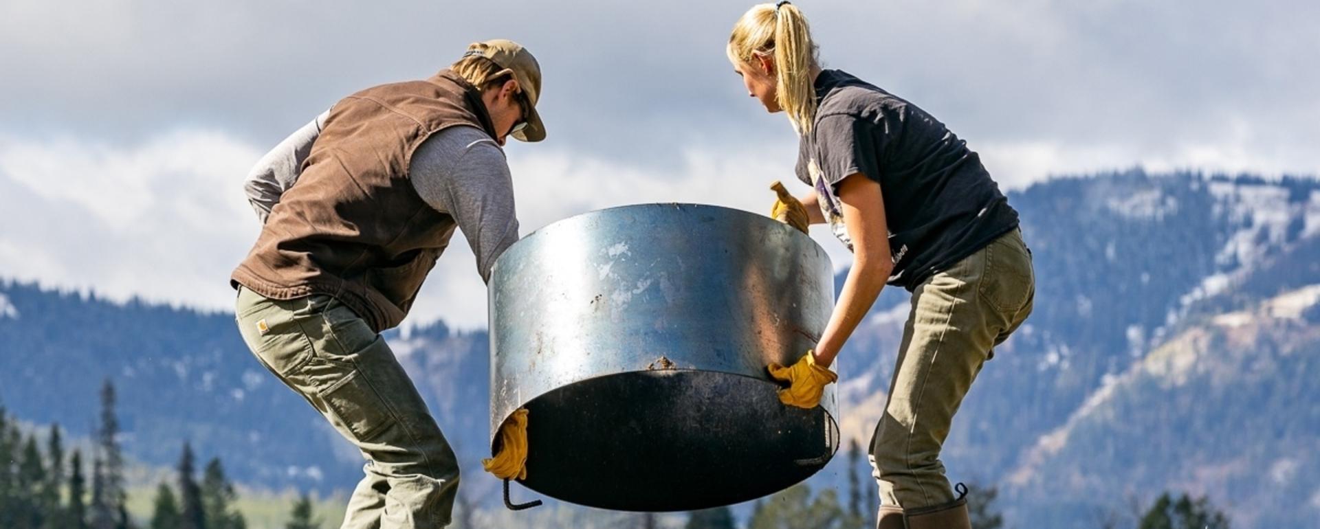 Workers install a fire ring at a campground for Friends of Bridger-Teton