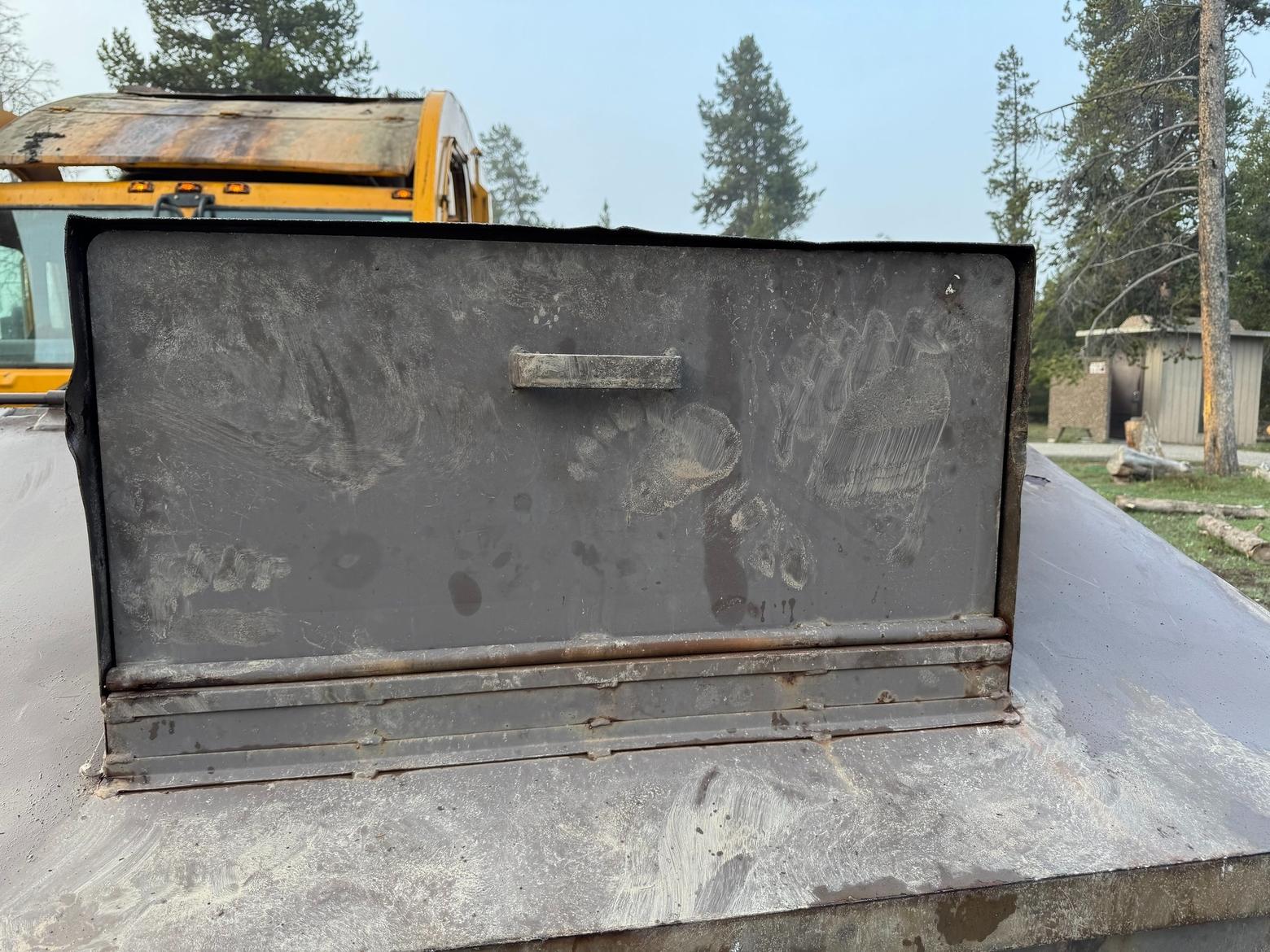 A grizzly bear paw print on a dumpster in Yellowstone National Park. Yellowstone staff euthanized a food-conditioned grizzly last week after the bear overturned 800-pound dumpsters and uprooted bear-resistant trashcans from their concrete bases. Photo by Allan Barker/NPS