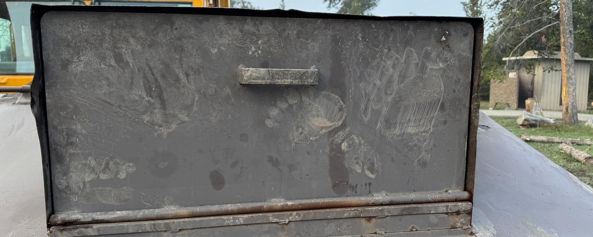 A grizzly paw print on a dumpster in Yellowstone National Park