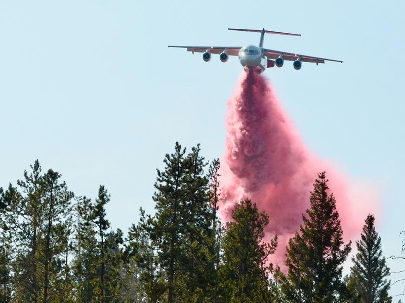 A Neptune Aviation BAe-146 jet drops fire retardant