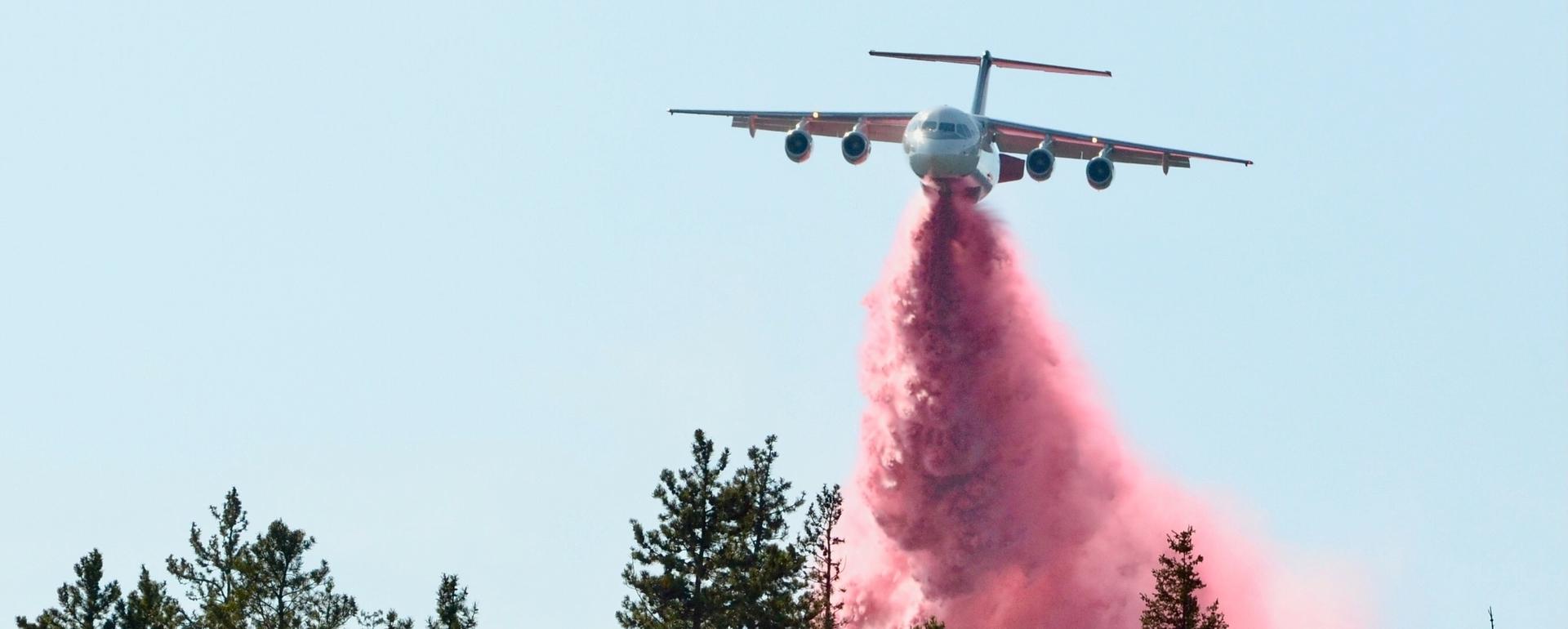 A Neptune Aviation BAe-146 jet drops fire retardant
